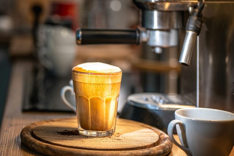 A cup of coffee sitting on top of a wooden table